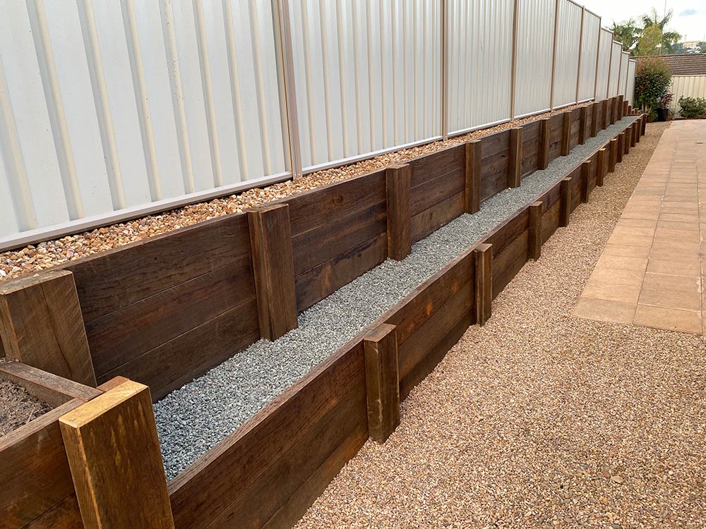 Double terrace hardwood retaining wall with color bond fence on top